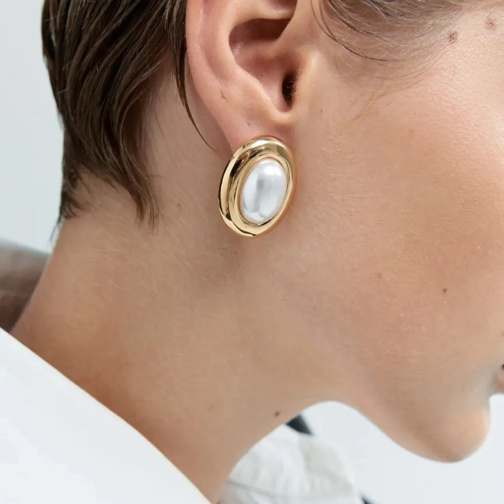 Close-up of women's stainless steel vintage pearl stud earrings with a 10mm white pearl.