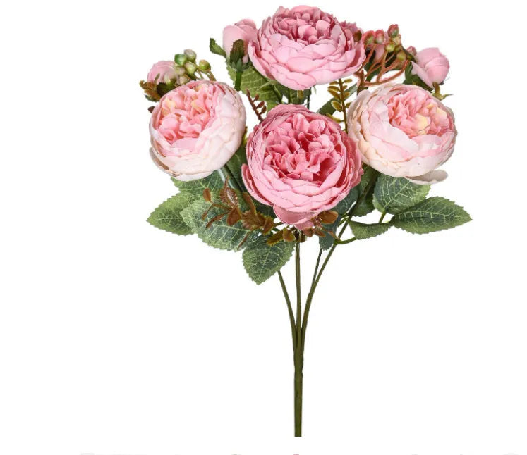 Artificial silk peony bouquet in a vase with champagne coloured blooms and green leaves