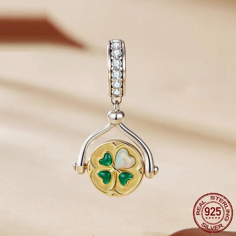 925 silver rotating card pendant with four-leaf clover pattern and wings motif on white background