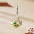 925 silver rotating card pendant with four-leaf clover pattern and wings motif on white background