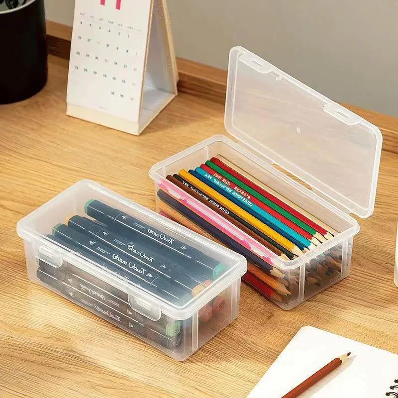 Transparent pencil storage box showing organised stationery including pencils and art supplies