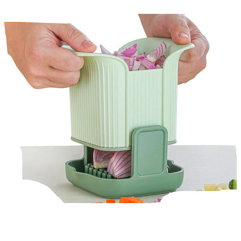 Green manual vegetable chopper with stainless steel blades for onions and potatoes.