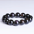 Polished crystal Pi Xiu bracelet with geometric ethnic design on a wrist, showing double eye ice stone pattern.