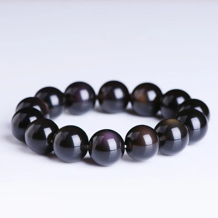 Polished crystal Pi Xiu bracelet with geometric ethnic design on a wrist, showing double eye ice stone pattern.
