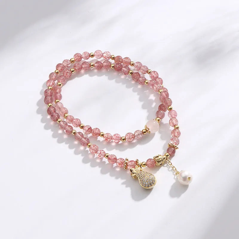 A geometric wallet bracelet for women made from pink strawberry quartz crystal.