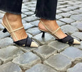 Women's apricot and black colour block stiletto heel sandals with pointed toe and buckle strap.