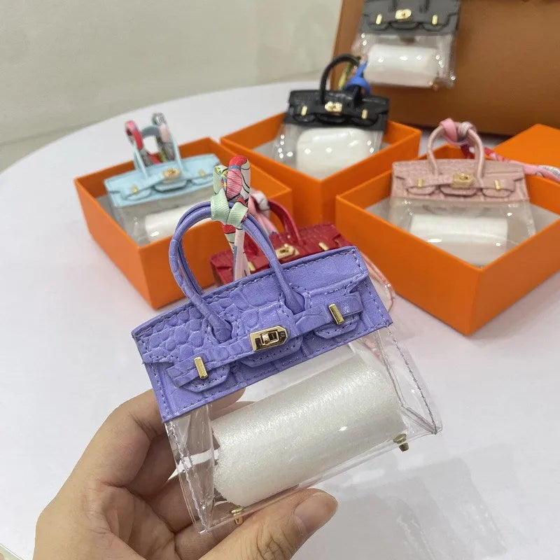 Women's fashion car key case in artificial leather showing crocodile print and palm print pattern options.