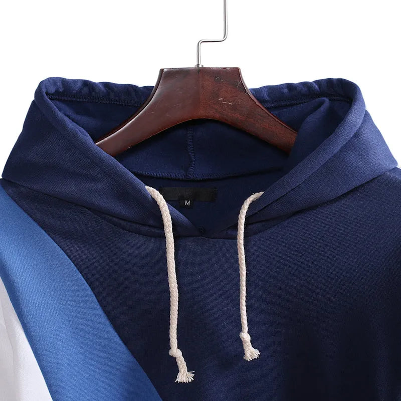 Casual men's loose hooded pullover sweater in blue-white with geometric colour-blocked stitching and save pockets