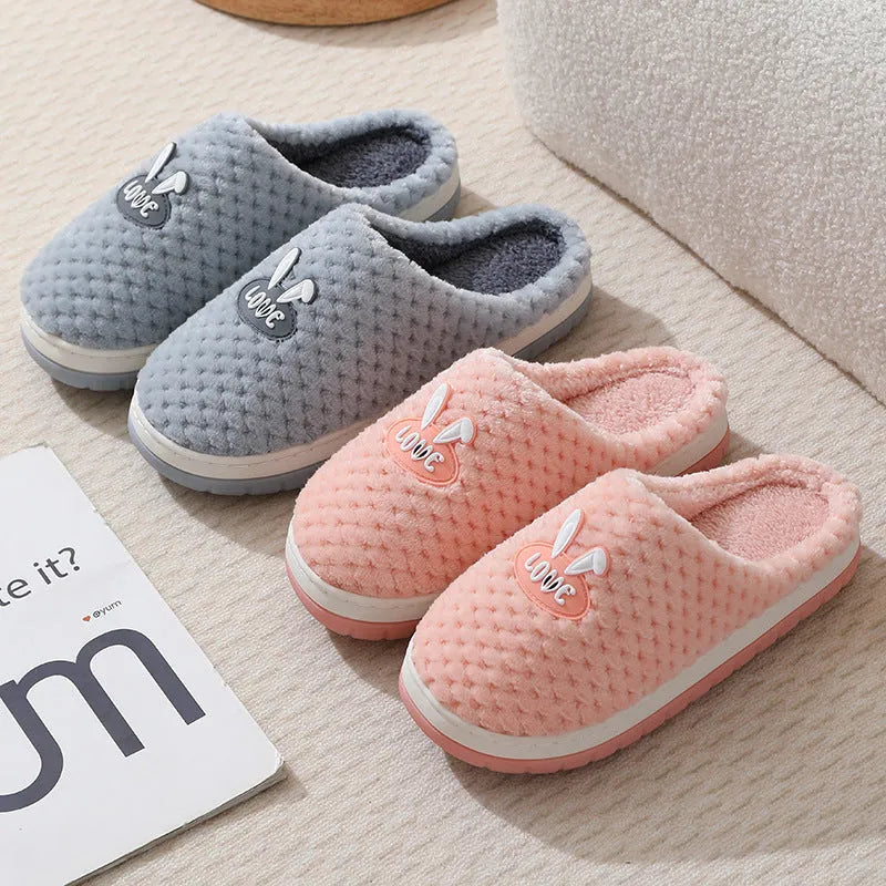Women's rabbit plaid design winter slippers with artificial fur upper and thick rubber sole.