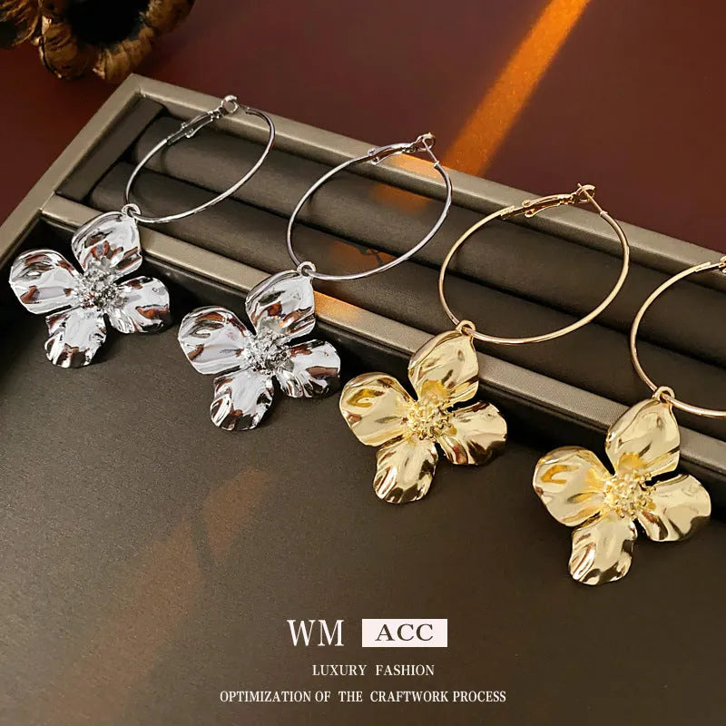 Geometric flower-shaped alloy earrings with a gold or silver electroplated finish.