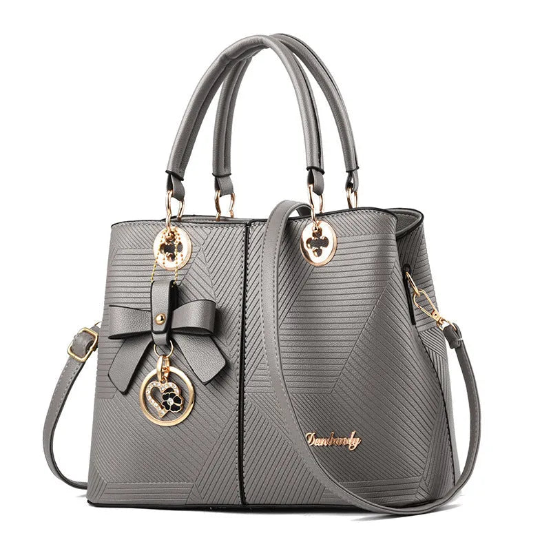 Retro style PU handbag in multiple colours showing zip opening and adjustable shoulder strap