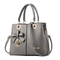 Retro style PU handbag in multiple colours showing zip opening and adjustable shoulder strap