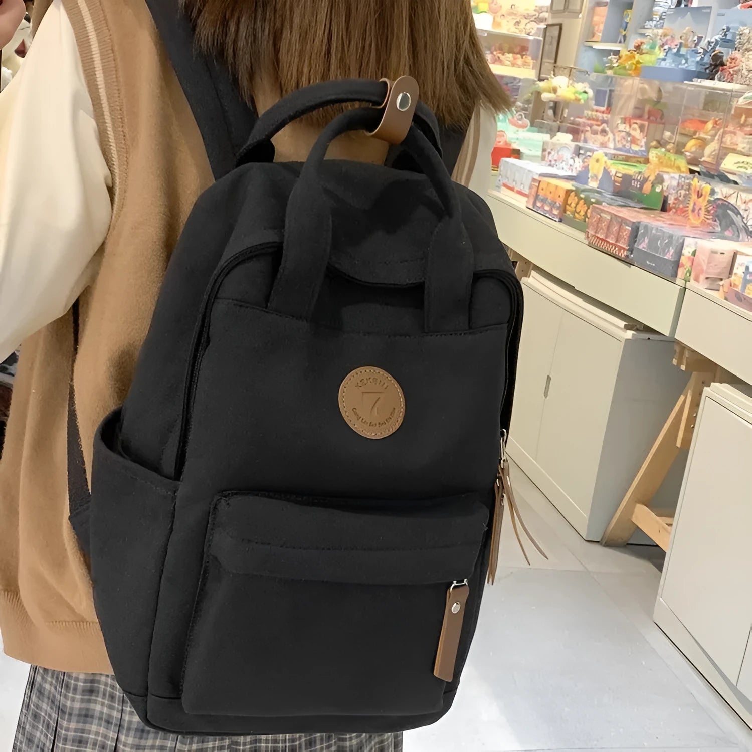 Black Oxford cloth fashion backpack with retro sewing thread detailing and curved shoulder straps