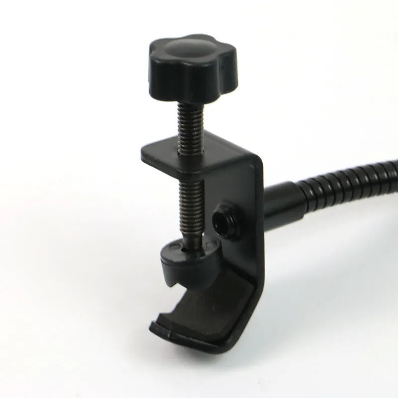 Black microphone anti-spray shock mount with elastic suspension bands on a stand