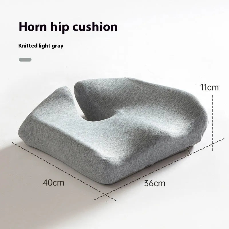 Black memory foam office chair cushion with a mesh lining, shown on a grey office chair seat.
