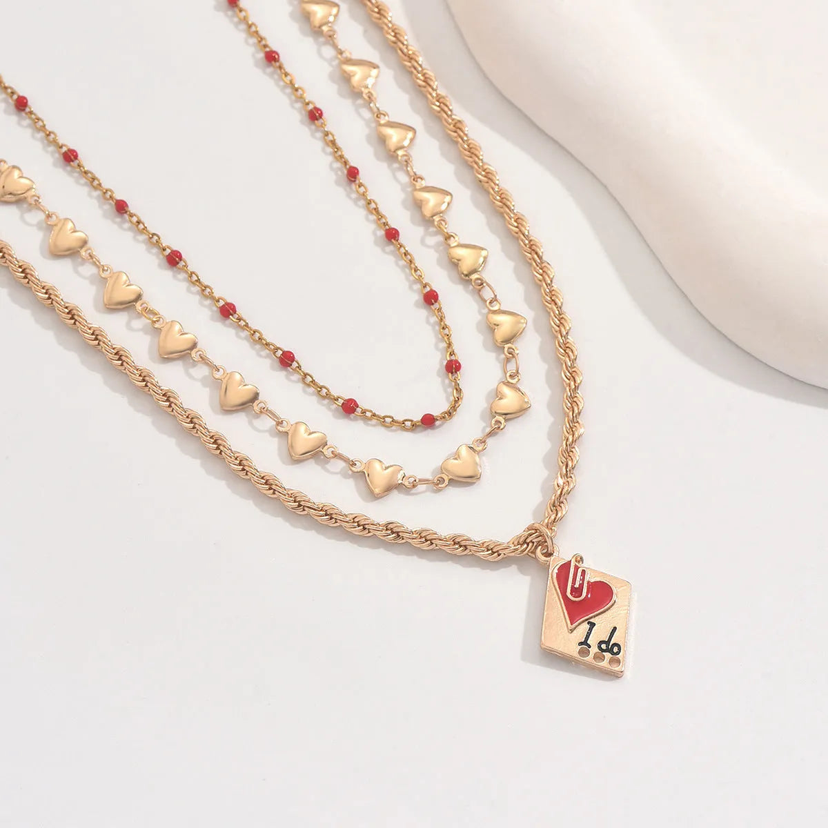 Three-layer clavicle necklace with geometric heart pendants on adjustable chain