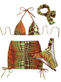 Printed split bikini set with chest pad, shorts, skirt, and headband in polyester on woman