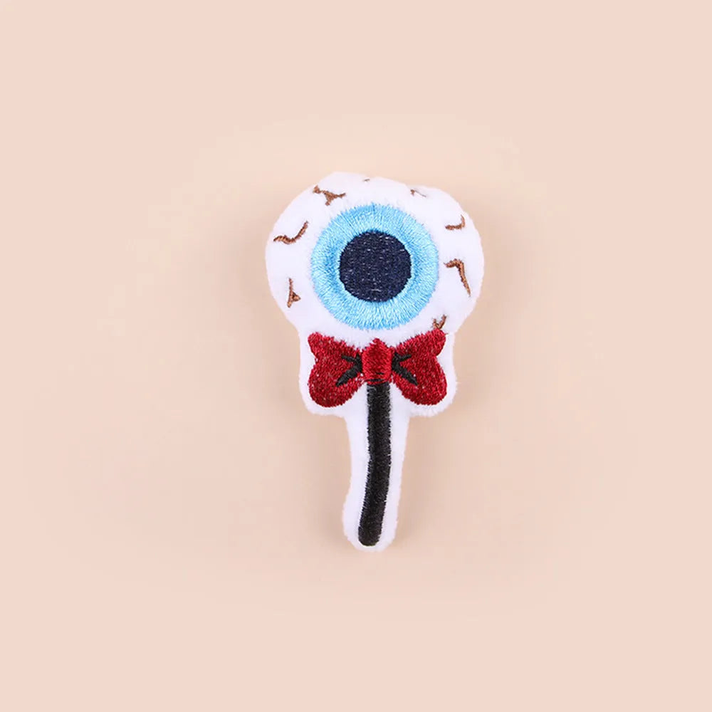Small plush cat teaser wand toy on a white background, showing eye, candy, and skull design options.