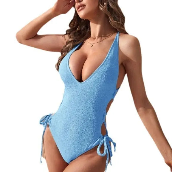 Women's solid colour hollow backless one-piece swimsuit in polyester, shown in light blue.