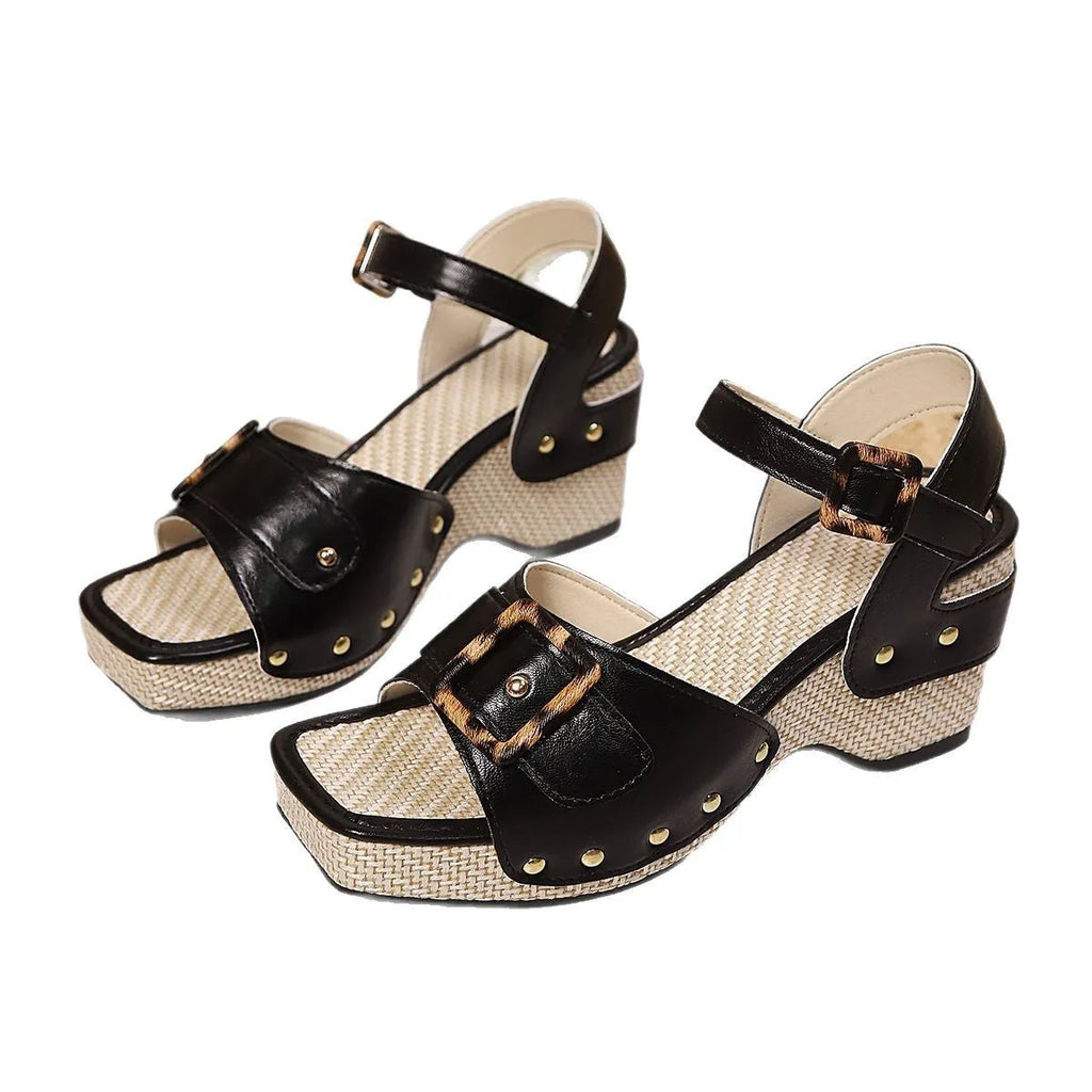 White women's chunky heel sandals with a square toe and large metal buckle fastening on the strap.