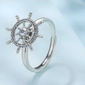 Retro women's silver ring with rotatable rudder design and inlaid zircon stone on open mouth band.
