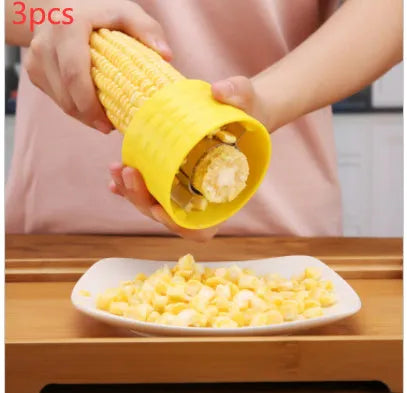 Yellow manual corn grinder thresher kitchen gadget with corn kernel shaped handle.