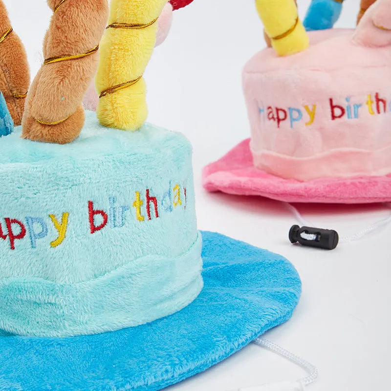 Blue and pink soft birthday hat for small dog on white background.