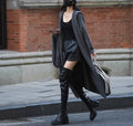 Long grey hooded knitted cardigan coat with loose fit and long sleeves.