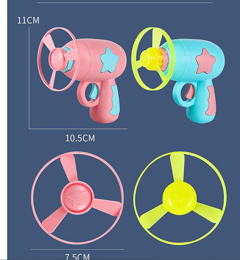 Blue plastic flying saucer launcher toy with LED-lit discs on a yellow target board.
