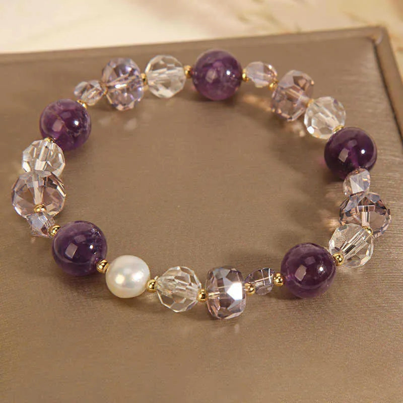 Women's artificial amethyst bracelet with four-leaf clover pendant and pearl accents on a U-shaped cuff.