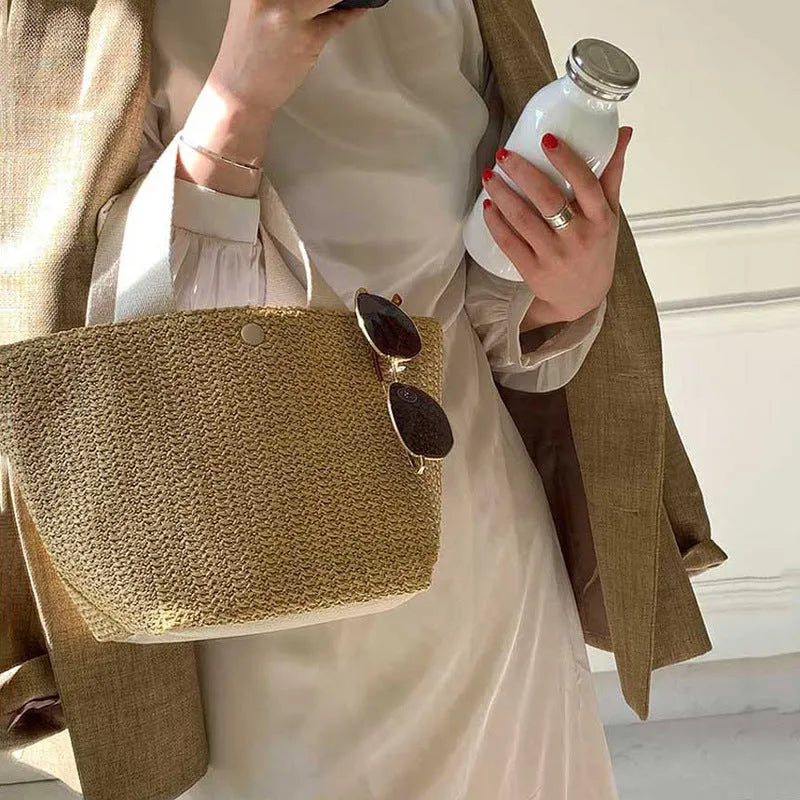 Casual rattan straw shoulder bag in black, bucket shape with shoulder strap