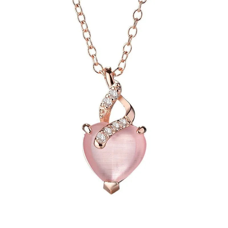 Women's pink heart crystal pendant necklace with rose gold chain on white background