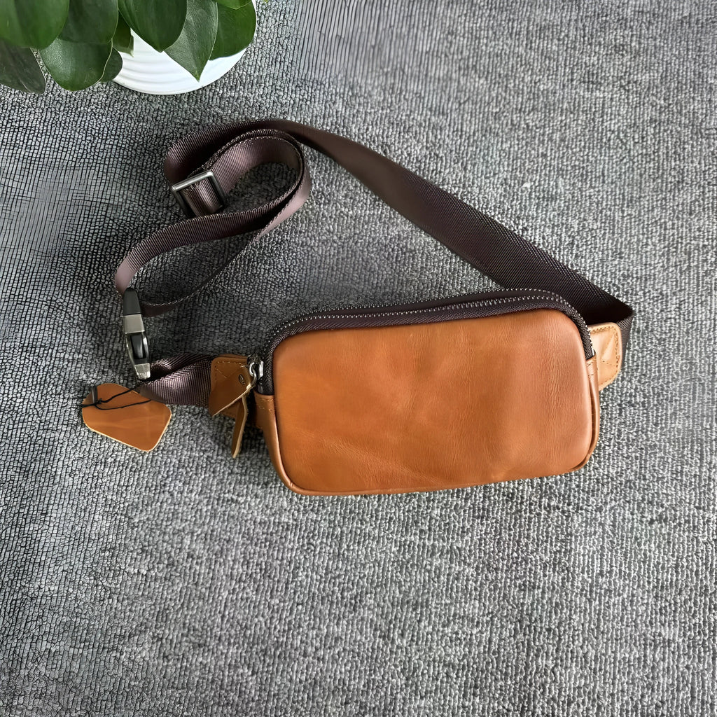 Small black cowhide leather crossbody bag for men with nylon lining.
