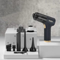 Black wireless handheld car vacuum cleaner and tyre inflator with multiple nozzle attachments on a white background.