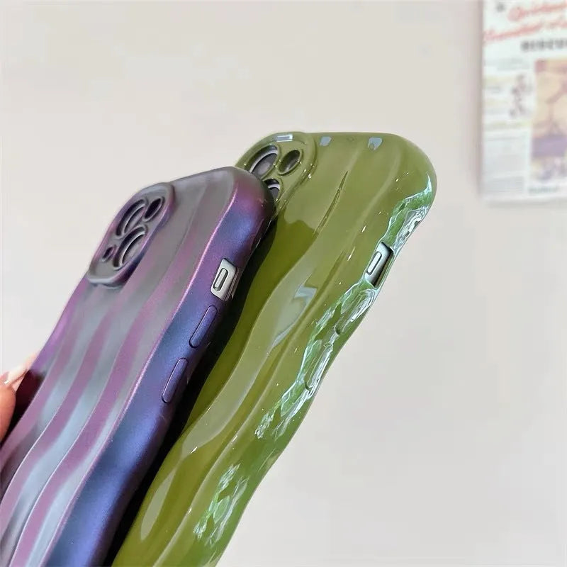 Silicone iPhone 17 case with a textured water ripple surface in green, shown fitted on a phone.