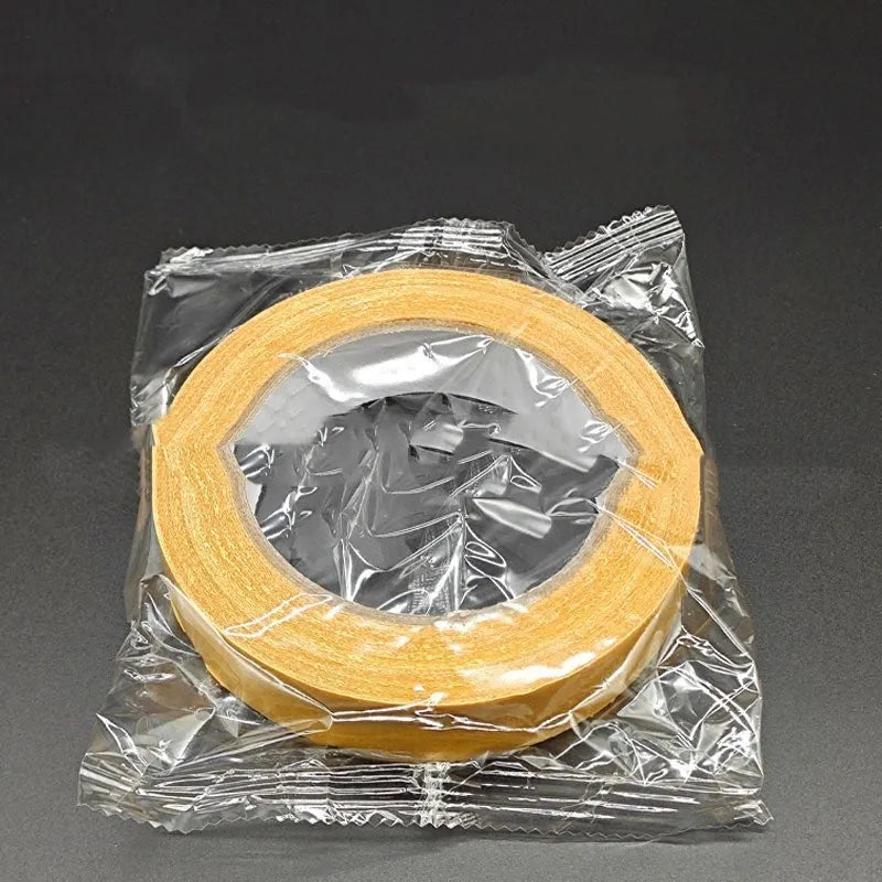 Roll of yellow grid double-sided cloth tape 5cm wide 20m long on white background