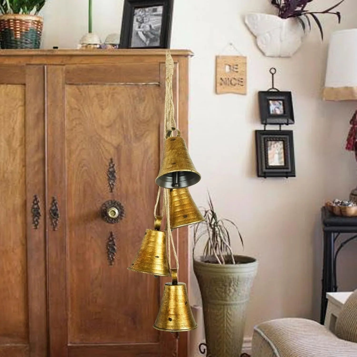 Four handmade metal bells in retro country style, each 11.5x8.5 cm, on a wooden surface