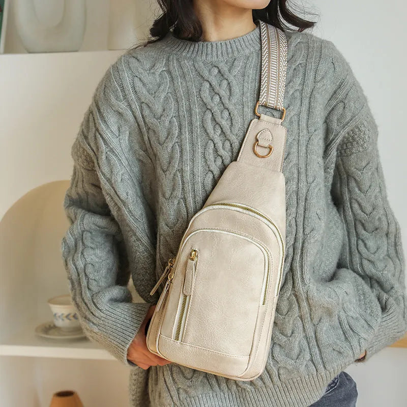 A soft PU women's crossbody messenger bag in beige, shown with an open outer pocket and decorative stitching.