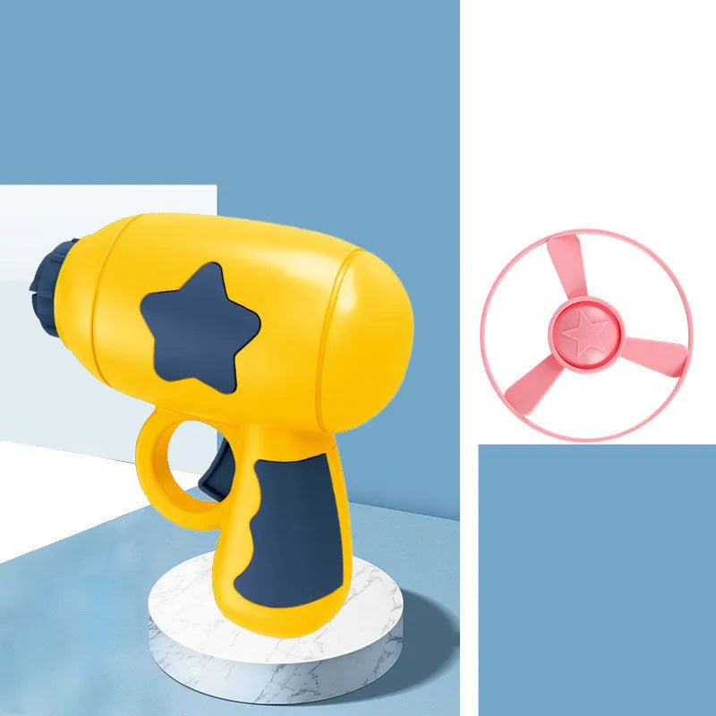 Blue plastic flying saucer launcher toy with LED-lit discs on a yellow target board.