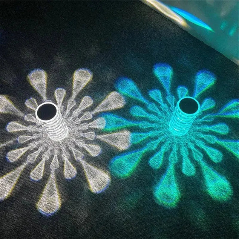 Crystal table lamp rechargeable with teardrop acrylic shade showing droplet shadow effect on a bedside table