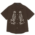 Man wearing brown striped waterproof short sleeve shirt with Cuban collar for outdoor camping.