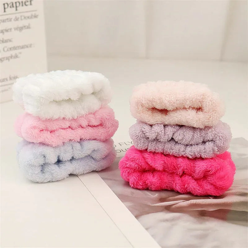 Coral velvet wrist washbands in white, pink, light blue, grey, and lavender for face washing and beauty routines.