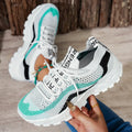 Women's black and white casual sports shoes with mesh upper and lace-up front.
