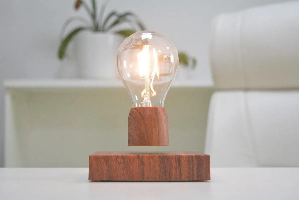 Magnetic levitation floating light bulb hovering above an imitation wood base.