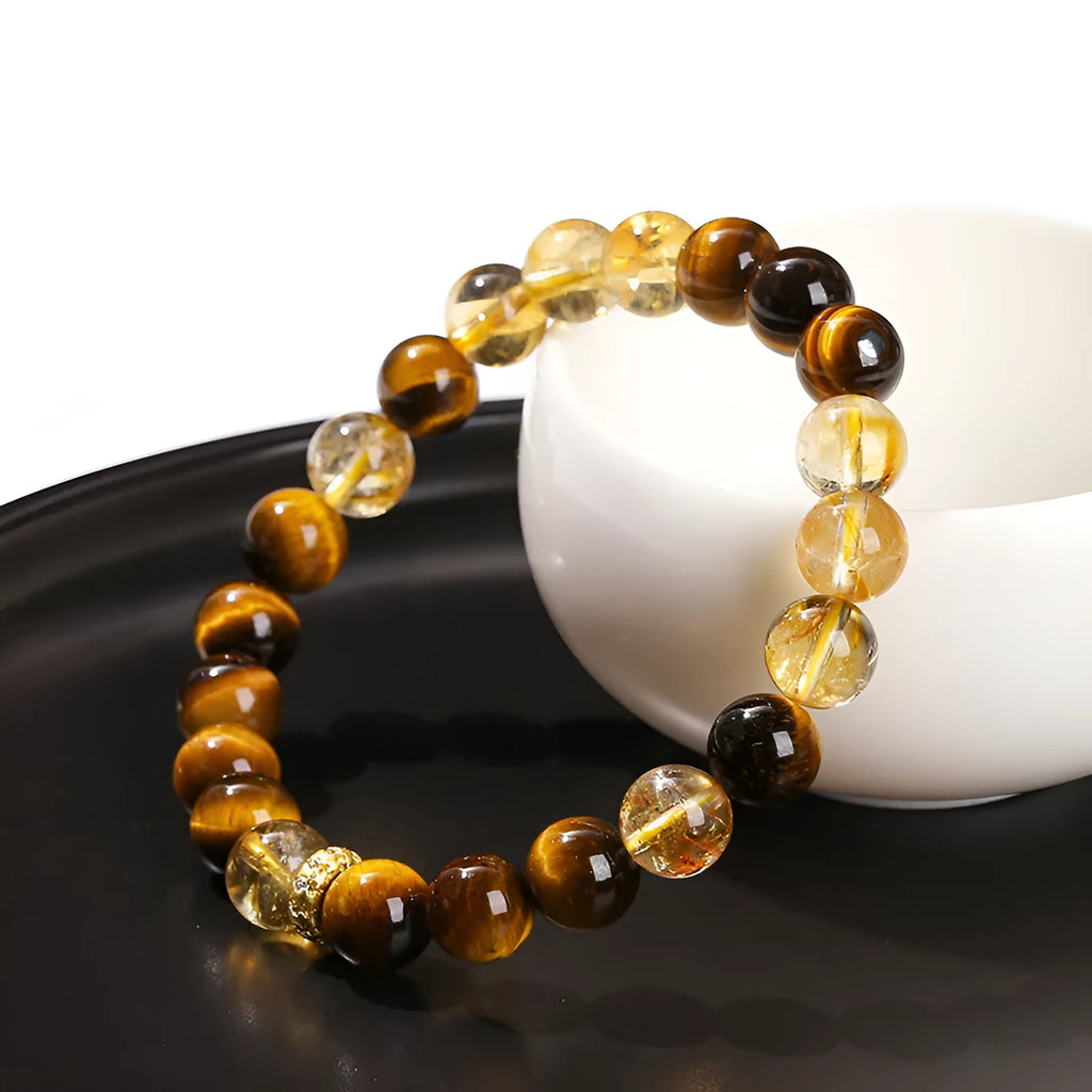 Close-up of a women's yellow tiger-eye stone and crystal bracelet with 8mm round beads.