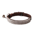 Pink flannel cat collar with elastic buckle and gang drill decoration on a textured flocked material.