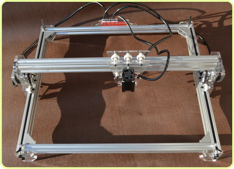 Miniature 3000mW laser engraving machine with a 400x300mm base plate for desktop marking.