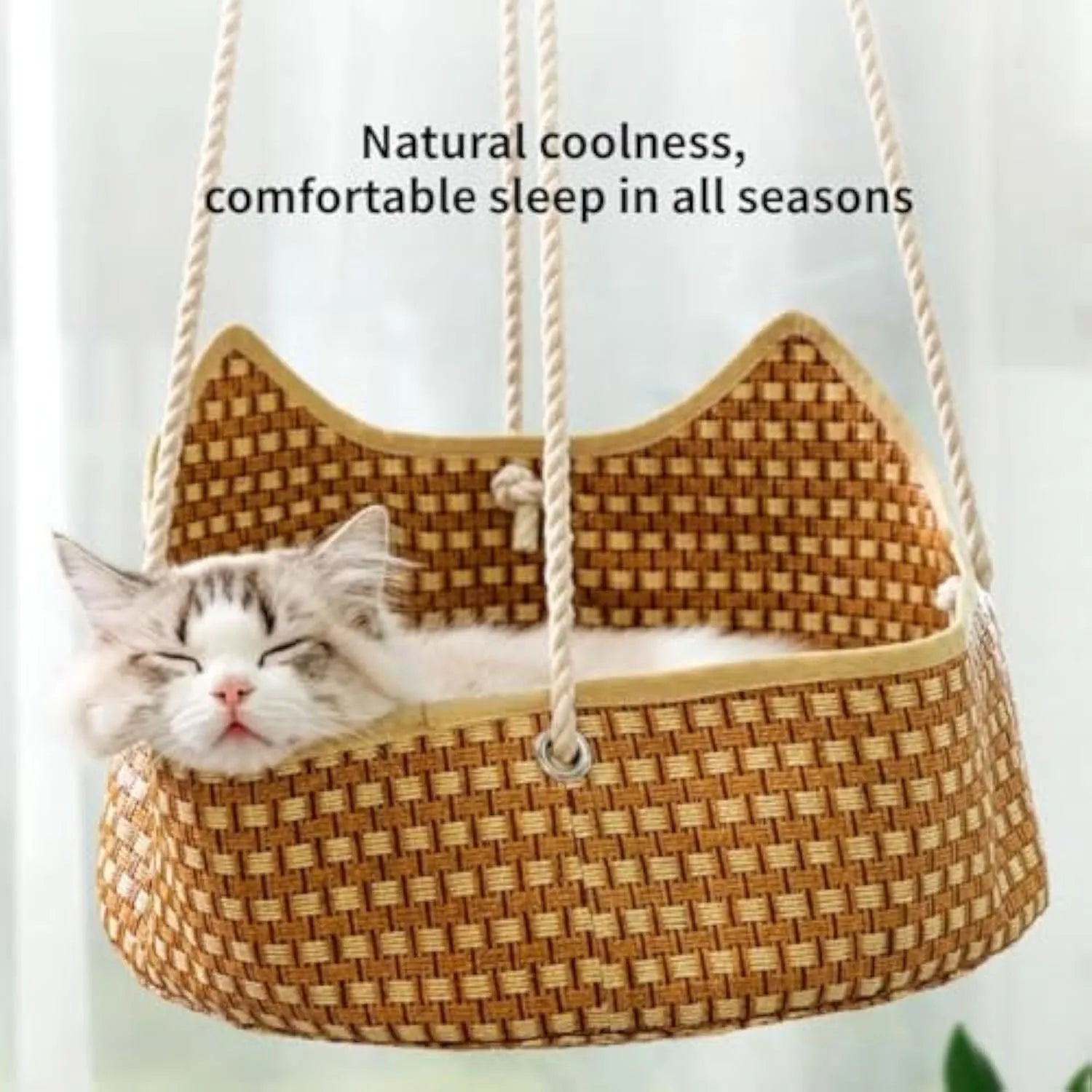 Green rattan cat hammock with metal hooks hanging from a shelf