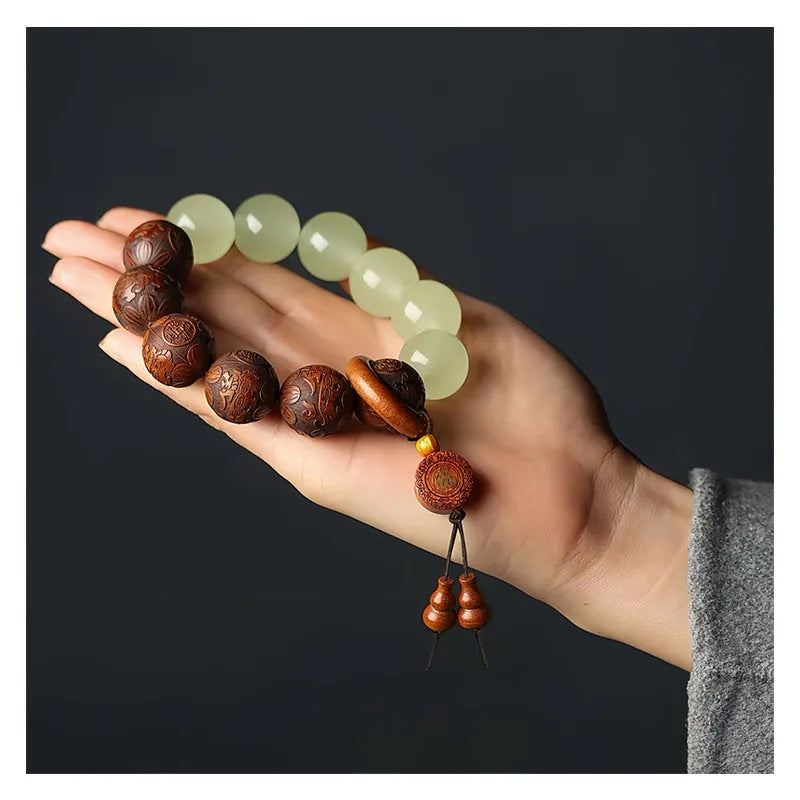 Rosewood bracelet with carved Fu character and amass fortunes design showing 12 wooden beads