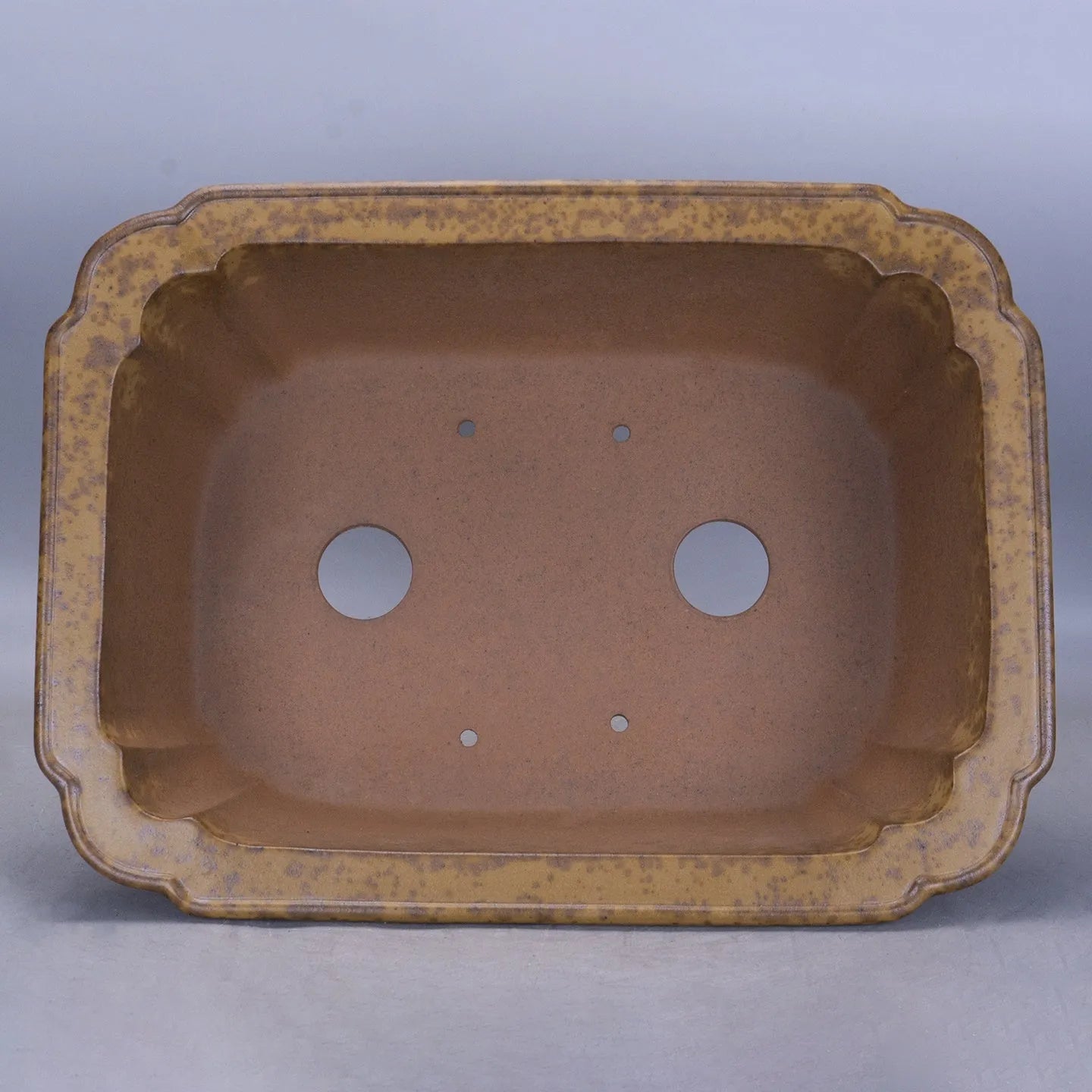 Large rectangular purple sand flowerpot with modern segmented design on a floor.